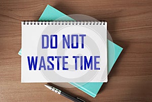 Don`t waste time, text words written on notepad, on wooden background, motivational inspirational life