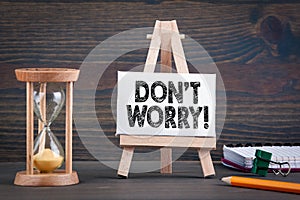 Don`t Worry. Sandglass, hourglass or egg timer on wooden table