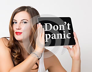 Don't panic written on virtual screen. technology, internet and networking concept. beautiful woman with bare shoulders photo