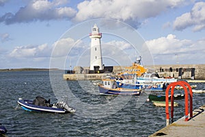 Donaghadee Lightouse and boats moored in Donaghadee Harbour
