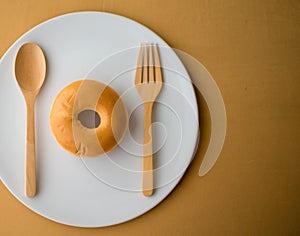 Donat fork spoon on white plate