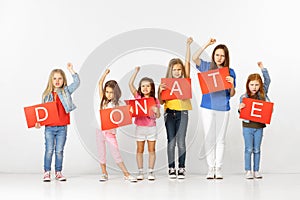 Donate. Group of children with red banners isolated in white