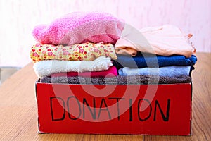 Donation box with clothes. A box of warm clothes.