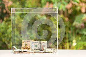 Donation box with money on table