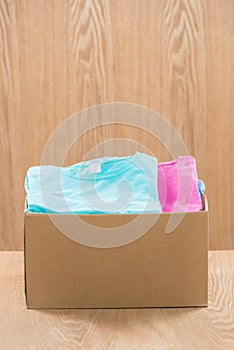 Donation box for poor with clothing in male hands