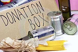 Donation carton box with food pasta, cans, beans and other. Volunteering and social assistance, charity concept