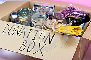 Donation carton box with food pasta, cans, beans and other. Volunteering and social assistance, charity concept.