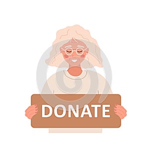 Donation and charity concept. Elderly volunteer woman holding in hands cardboard sign Donate. Support for homeless and