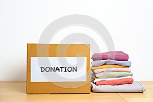 Donation, Charity, Volunteer, Giving and Delivery Concept. Clothes with Donation box at home or office for support and help poor,