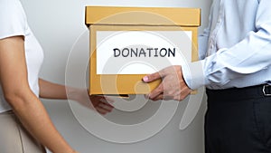 Donation, Charity, Volunteer, Giving and Delivery Concept. People donate Clothes and Food into Donation box at home or office for
