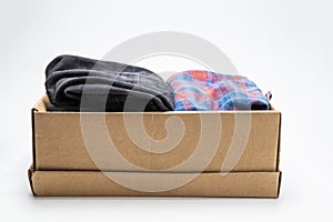 Donation concept. box with donation clothes on a white background. Charity Help for people in need