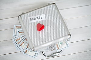 Donation Concept. Case with Dollars on White Background. Donations. High Resolution