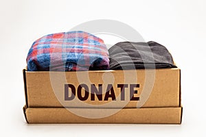 Donation concept. Donation box with donation clothes on a white background. Charity. Helping needy people