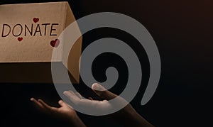 Donation Concept. The Volunteer Giving a Donate Box to the Receiver