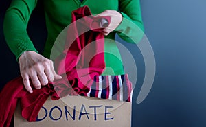 Donation Concept. Woman Preparing her Used Old Clothes into a Do