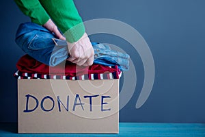 Donation Concept. Woman Preparing her Used Old Clothes into a Do