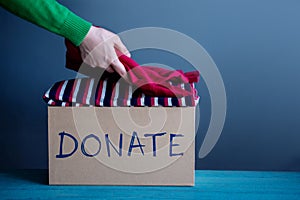 Donation Concept. Woman Preparing her Used Old Clothes into a Do