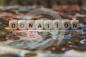 Donation - cube with letters, money sector terms - sign with wooden cubes