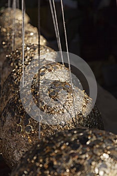 Donation with gold leaf in a Buddhism Temple