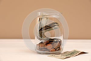 Donation jar with money on table