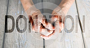 Donation Transparent Text Effect, old and young hands, red heart image cut, white background.