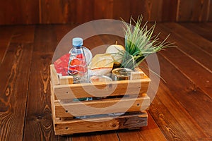 Donation volunteer box with various products for poor or elderly people on wooden background