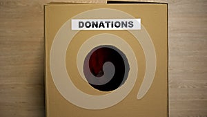 Donations cardboard box with clothes, volunteering organization, charity
