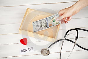 Donations and Charity. Donation Concept. Box of Donations and Heart on the White Background.