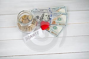 Donations and Charity. Donation Concept. Glass with Donations on White Background. Inscription Donate. Charity and Money