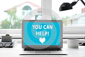 Donations concept. Laptop with text YOU CAN HELP in office