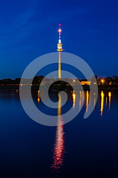 Donauturm in Vienna reflecting on danube river during night...IMAGE photo