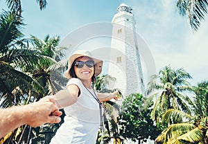 Dondra lighthouse in Sri Lanka: woman traveler take for hand her