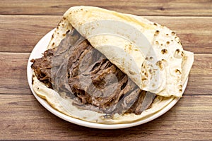 Doner kebab on a wooden background. Traditional Turkish cuisine flavor meat doner