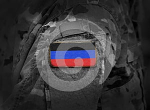 Donetsk People`s Republic flag on soldiers arm. collage