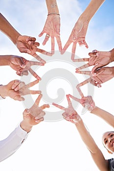 Dont allow your light to be put out. a group of unrecognizable people making a star shape with their fingers outside.