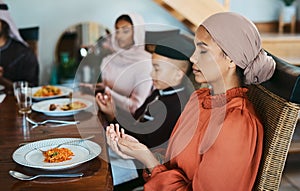 Dont forget to bless your meal. a muslim family praying before eating.