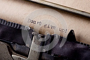Dont give up - text message on the typewriter close-up