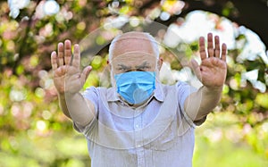 Dont go outdoor. observe precautions while pandemic. healthy life. wear mask in blossoming pink sakura park. man at