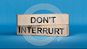 Dont interrupt symbol. Concept word Dont interrupt on wooden blocks. Business and Dont interrupt concept photo