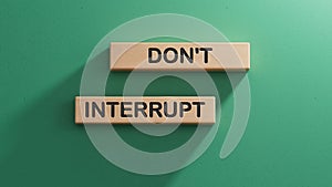 Dont interrupt symbol. Concept word Dont interrupt on wooden blocks. Business and Dont interrupt concept. photo