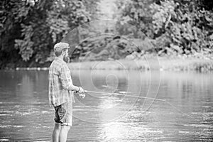 Dont look back. experienced fisher in water. fisherman show fishing technique use rod. man catching fish. mature man fly