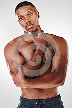 Dont misconstrue and dont misapprehend. Studio portrait of a shirtless handsome young man posing against a white photo