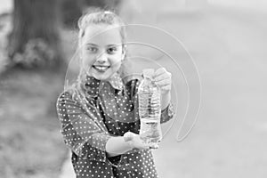 Dont wait, hydrate. Bottle of potable water selective focus. Little girl drinking water to quench thirst. Thirsty child