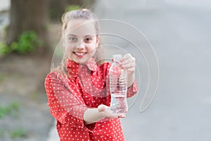 Dont wait, hydrate. Bottle of potable water selective focus. Little girl drinking water to quench thirst. Thirsty child