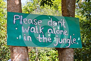 Dont walk alone in the jungle sign board on the tr