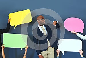 Dont waste your time listening to the naysayers. people holding up speech bubble around a young man.