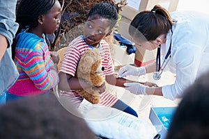 Dont worry, it doesnt hurt. volunteer nurses giving checkups to underprivileged kids. photo