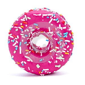 Donut coated with a pink frosting and sprinkles of different col