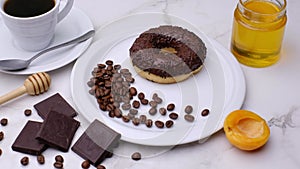 Donut with coffee and chocolate. Close-up 4k video footage, white background.