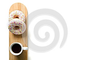 Donut and coffee on a serving wooden board. Beautiful design of the morning table or breakfast.